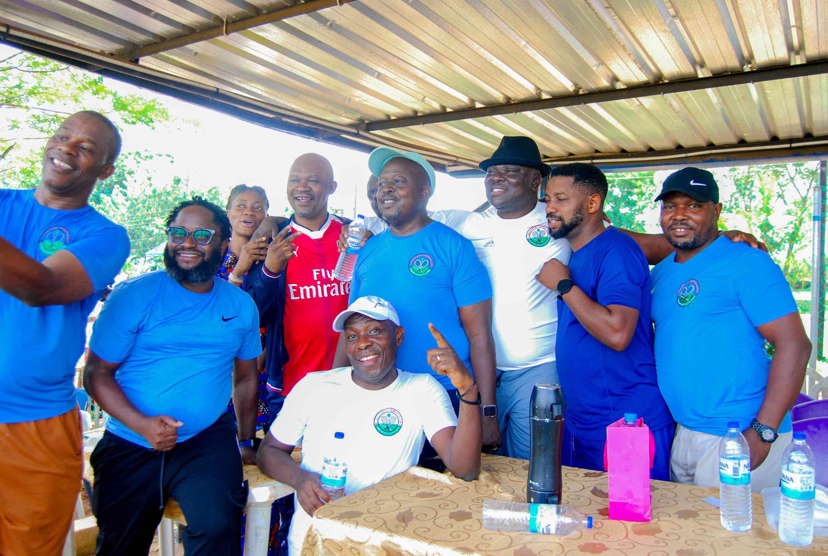 Sports couple with padel rackets posing on tennis court